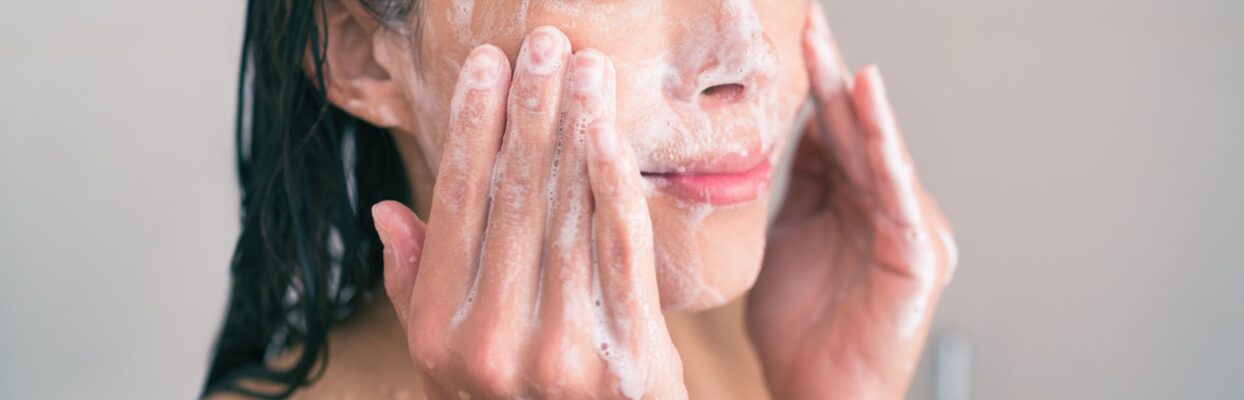 woman washing face with personal care face wash
