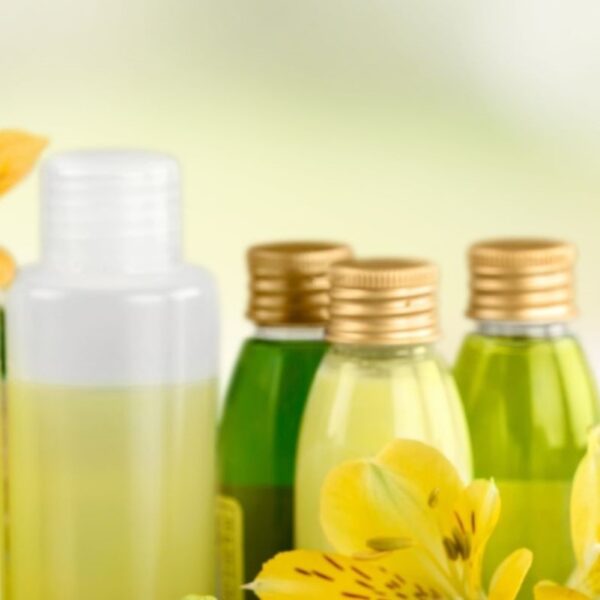 liquid soaps arranged with herbal flowers against a blurred background